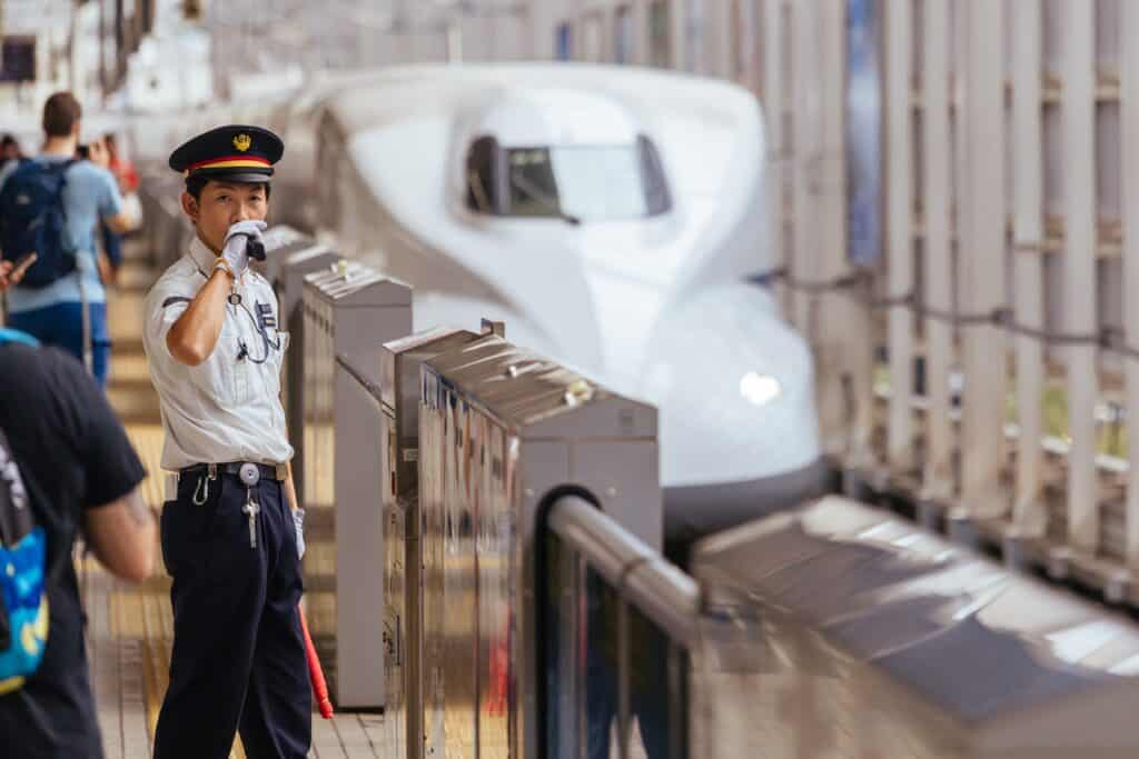 Railway staff member on a Shinkansen platform in Japan