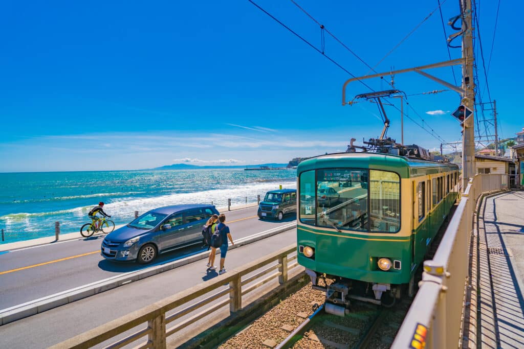 Enoden train running along the coast near Kamakura Japan