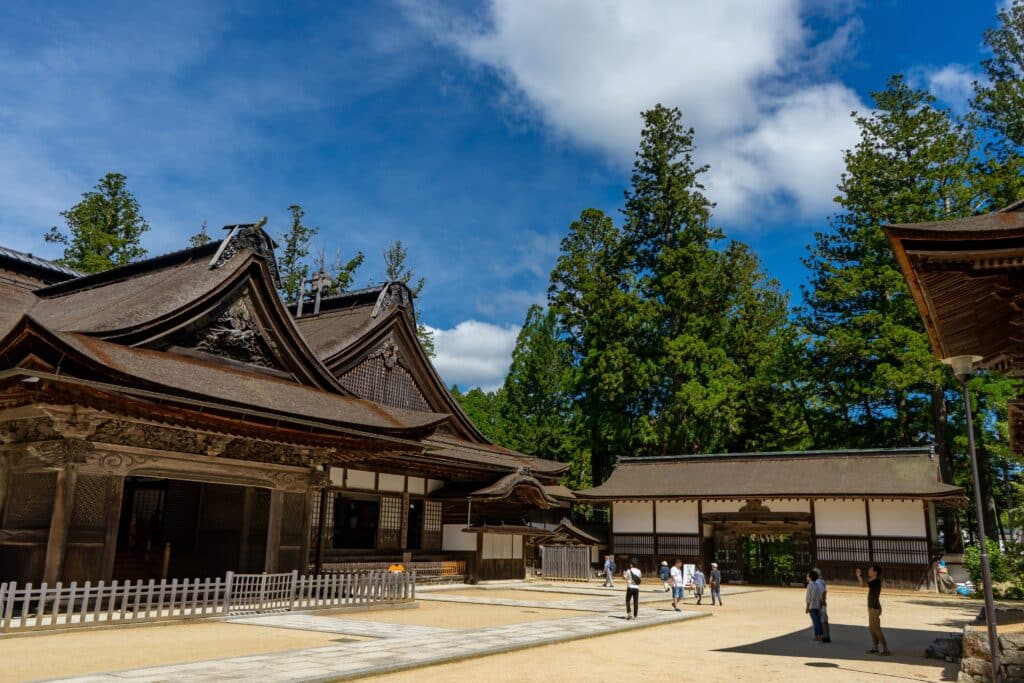 Traditional Buddhist temple buildings and courtyard surrounded by trees in Koyasan, Japan