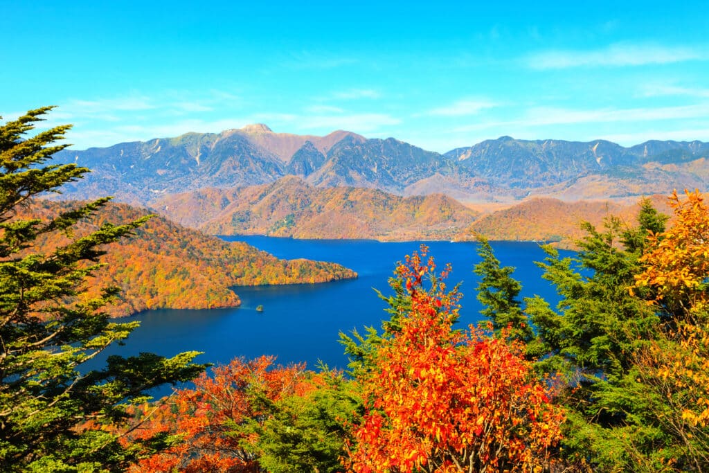 Lake Chuzenji surrounded by autumn mountains in Nikko Japan
