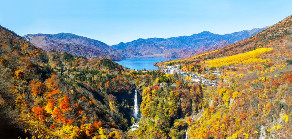 Kegon Falls and Lake Chuzenji surrounded by autumn foliage in Nikko