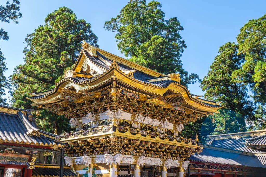 Ornate architecture of Toshogu Shrine surrounded by cedar trees in Nikko