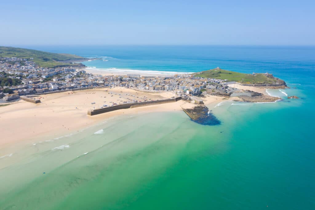 Aerial view of St Ives and its sandy beaches surrounded by turquoise sea