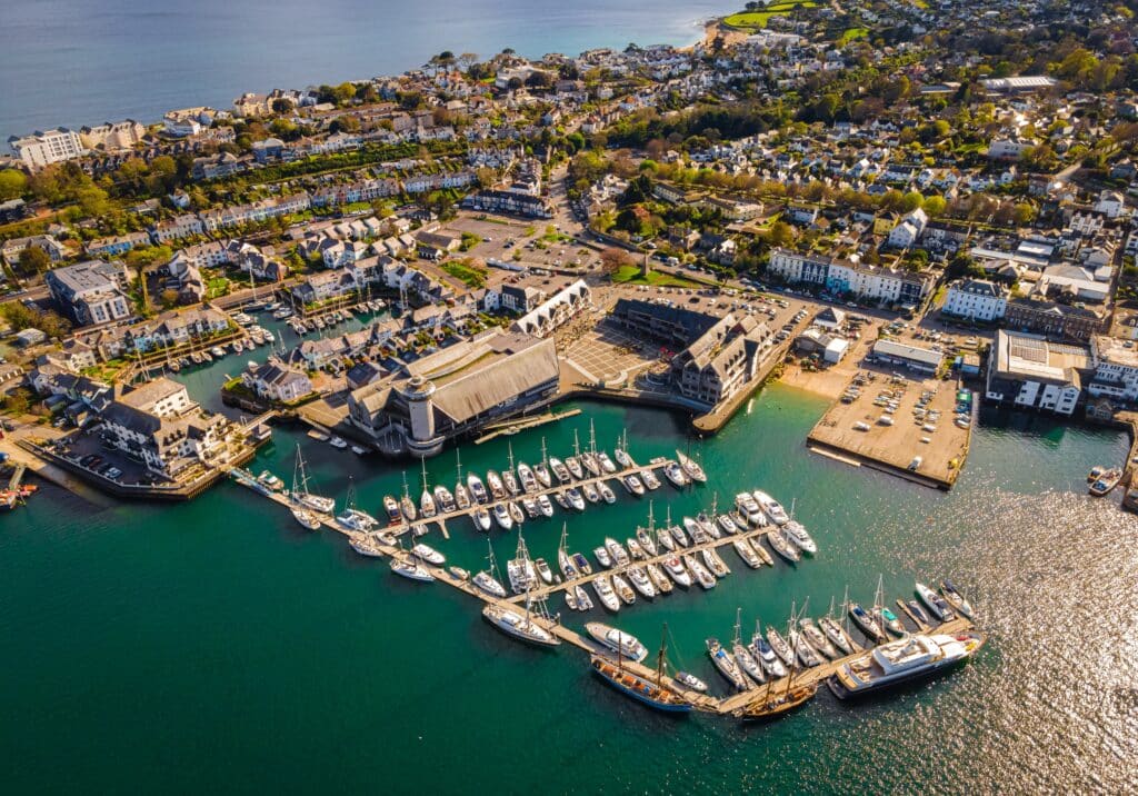 Aerial view of Falmouth marina in Cornwall, with yachts, waterfront buildings and the town overlooking the harbour
