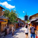 raditional Kyoto street leading toward Yasaka Pagoda under a bright blue summer sky