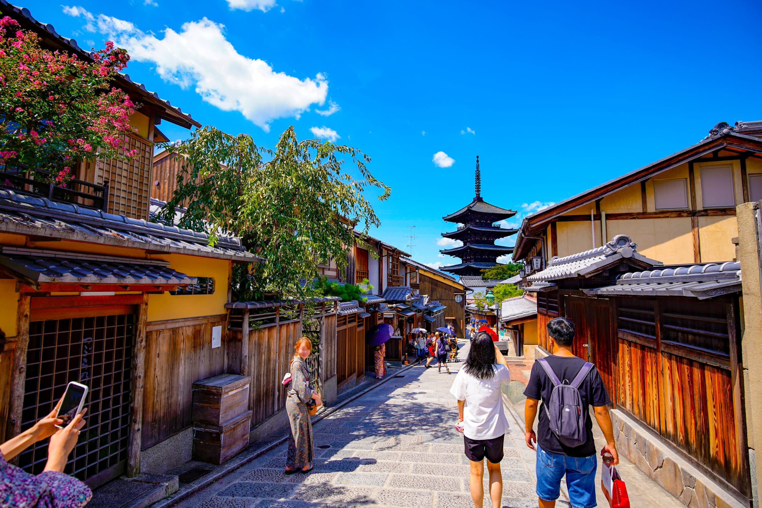 raditional Kyoto street leading toward Yasaka Pagoda under a bright blue summer sky