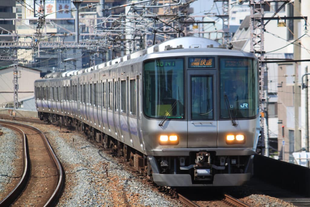 JR West Special Rapid train traveling on railway tracks, representing the convenient train connection between Kyoto and Osaka