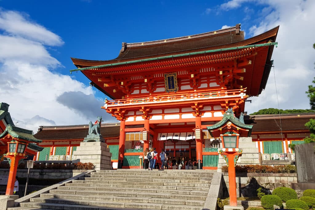 Vermilion entrance gate of Fushimi Inari Shrine in Kyoto on a bright sunny day