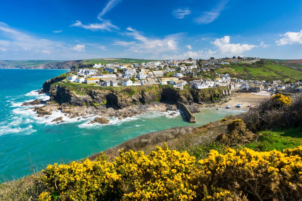 ort Isaac fishing village on the North Cornwall coast, with white cottages overlooking a small harbour and rocky cliffs