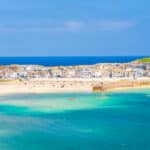 Panoramic view of St Ives Harbour in Cornwall, with sandy beaches, turquoise water and historic waterfront buildings