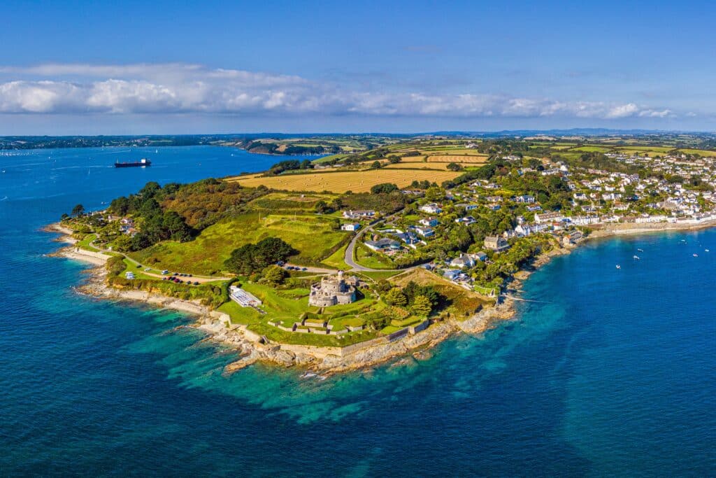 Aerial view of St Mawes Castle and the Roseland Peninsula in South Cornwall, with sheltered blue waters, coastal villages and green countryside