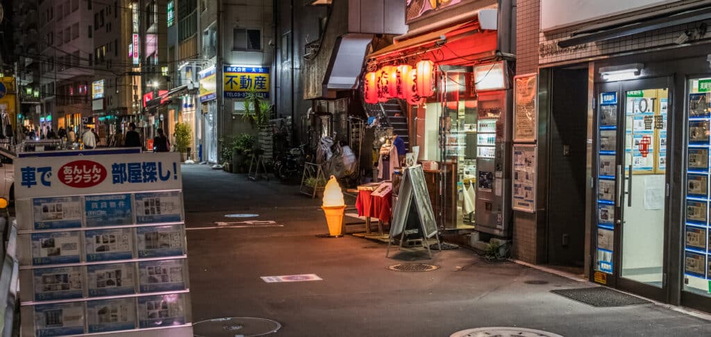 Local Tokyo street with restaurants at night in Japan