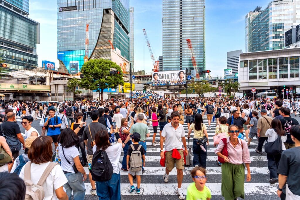 Large crowds of pedestrians crossing Shibuya Crossing in Tokyo during daylight